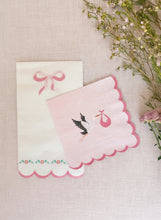 Load image into Gallery viewer, Pink embroidered card with scalloped edge and stork design on a textured surface with flowers.