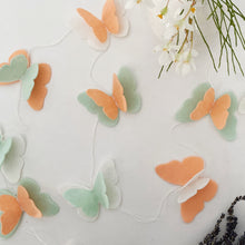 Load image into Gallery viewer, Peach, mint Butterfly felt garland for party and room decoration next to flowers and lavender - Pooka Party