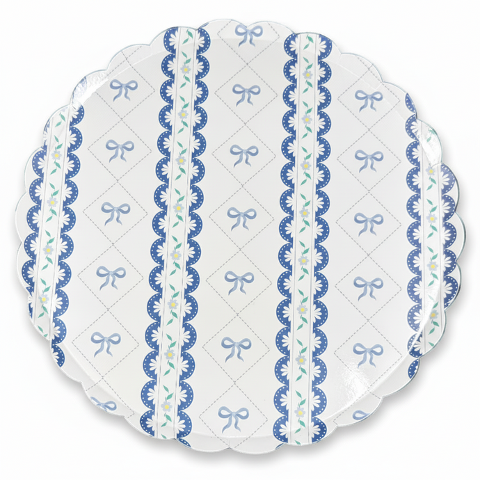 Close-up of blue bow scalloped paper plate design with floral details