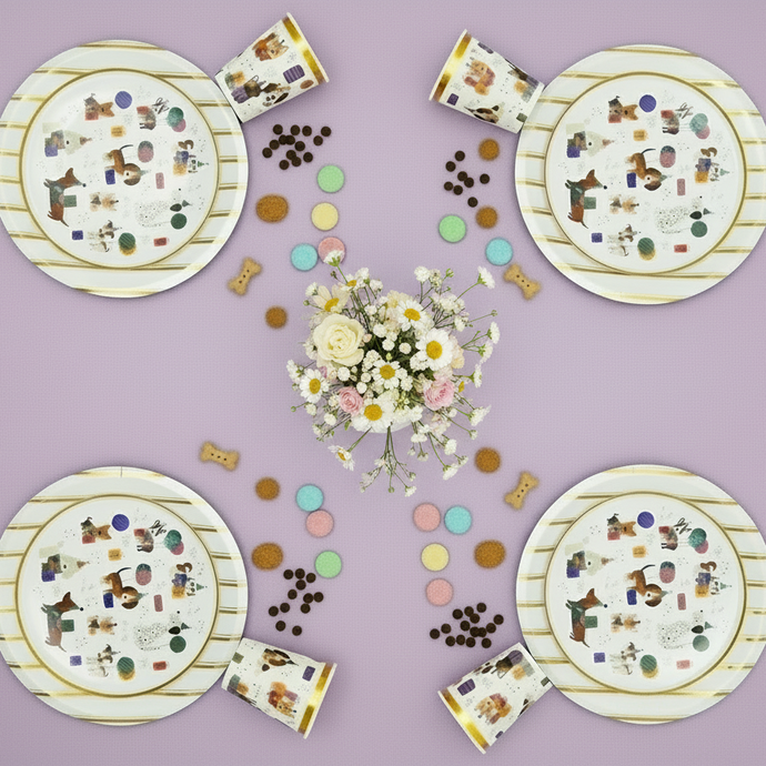 Set of paper plates and cups with dog illustrations on a purple background