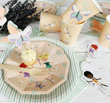 Load image into Gallery viewer, Party supplies with fairy design on plates, cups, and cutlery on a striped surface.
