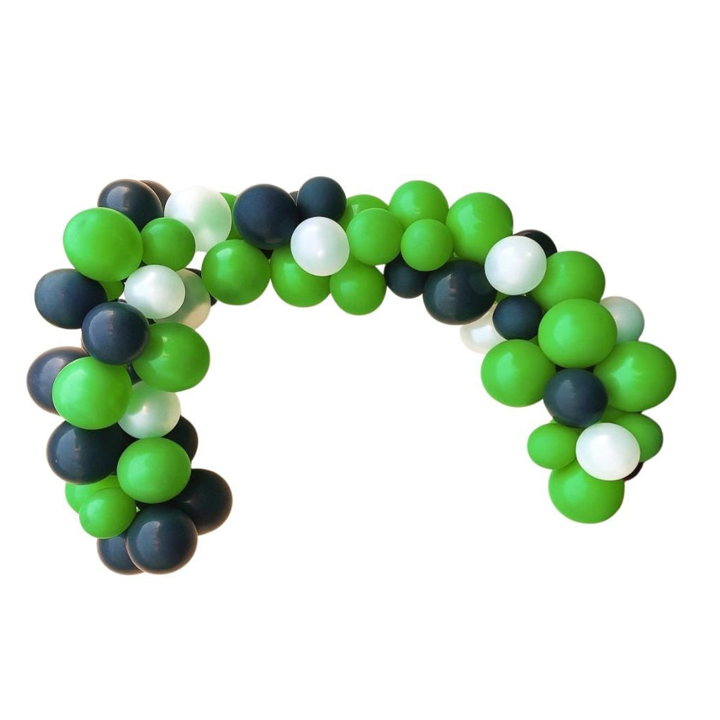 Balloon arch made of green, black, and white balloons